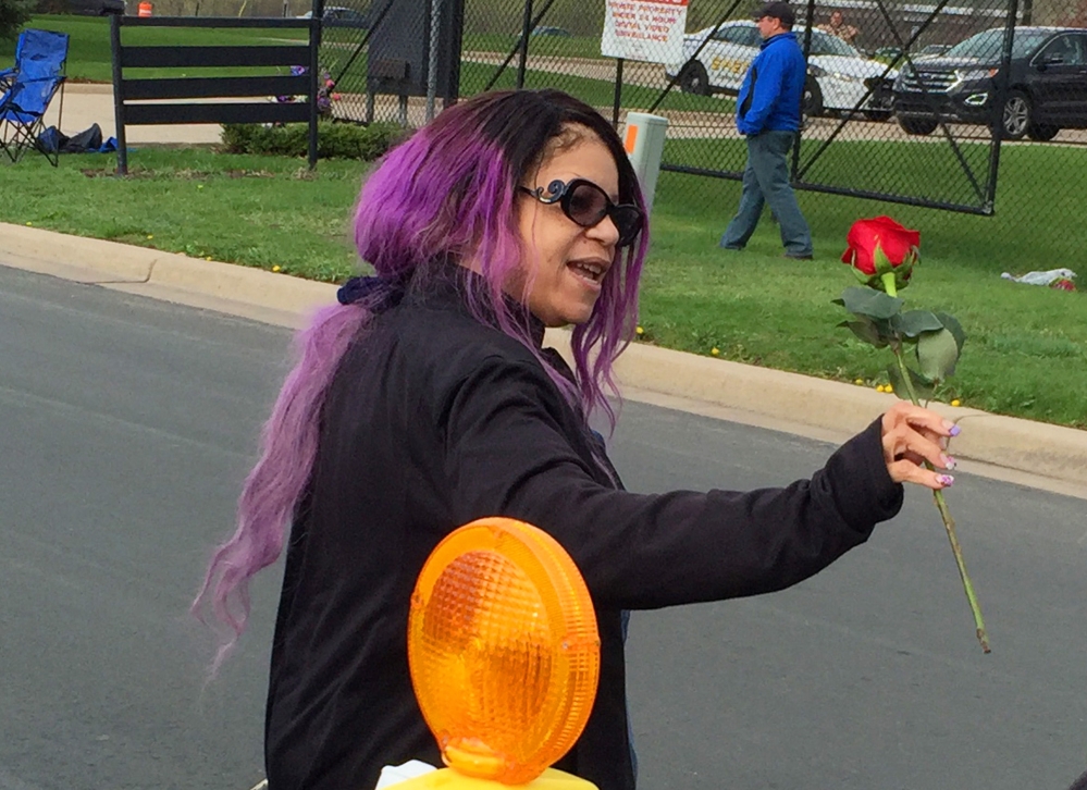 Prince's sister, Tyka Nelson, holds a rose outside Paisley Park, the home of her brother, in Chanhassen, Minn., last week. Nelson went out to thank fans who gathered at the home to mourn the loss of the pop star, who died April 21. Investigators are now trying to determine whether Prince died of a drug overdose.