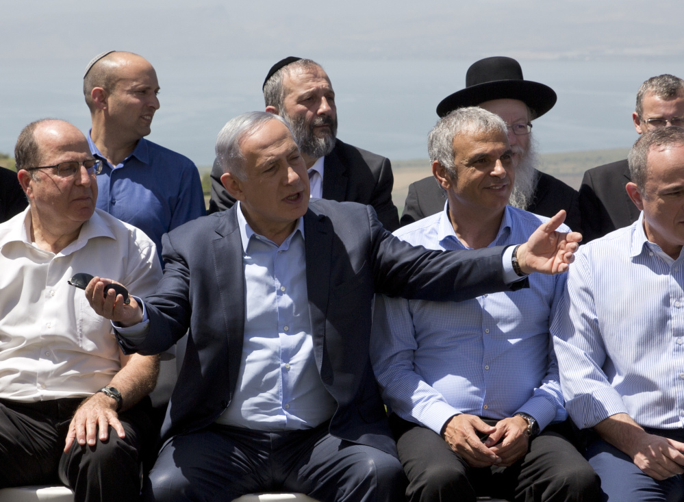 Israeli Prime Minister Benjamin Netanyahu, center, poses with cabinet ministers in the Golan Heights on April 17. He sparked criticism by calling the area "sovereign" Israeli territory.