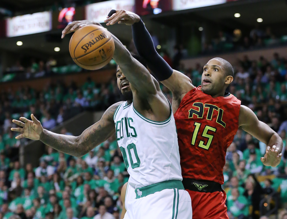 Atlanta center Al Horford knocks a rebound away from Celtics forward Amir Johnson in the first half of Game 6 Thursday night in Boston.