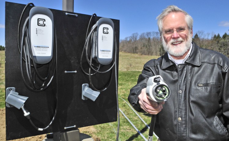 Scott Cowger, co-owner of the Maple Hill Farm Inn and Conference Center, demonstrates a newly installed electric car charger at his business in Hallowell.