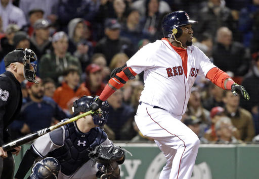 Red Sox designated hitter David Ortiz watches a two-run homer in front of New York Yankees catcher Brian McCann during the eighth inning of Friday night's game at Fenway Park.