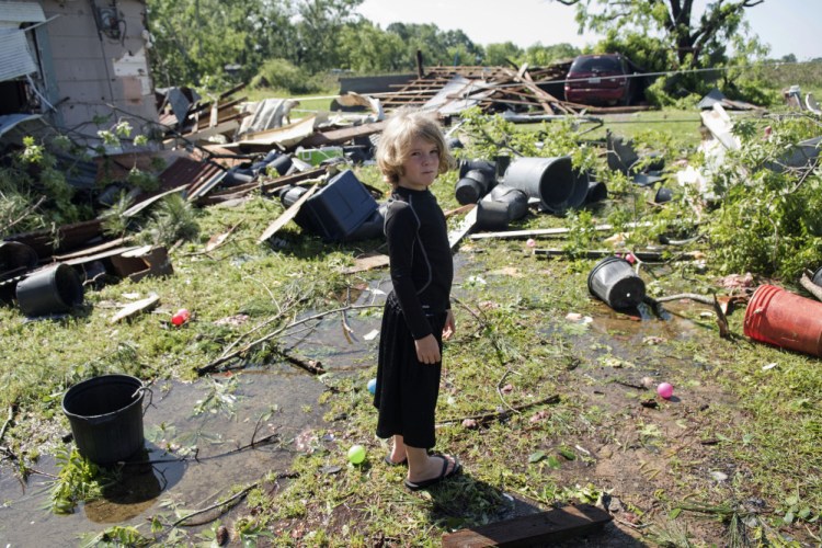 Memphis Melton, 7, looks at the destruction in his aunt's backyard in Lindale, Texas Saturday.