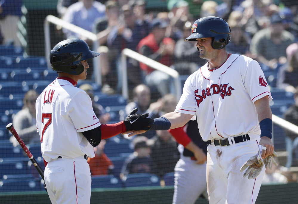 Portland's Jordan Betts, right, is congratulated by teammate Tzu-Wei Lin after Betts scored for the Sea Dogs against the Reading Fightin Phils on Saturday. The Sea Dogs won, 6-3. (Photo by Shawn Patrick Ouellette/Staff Photographer)