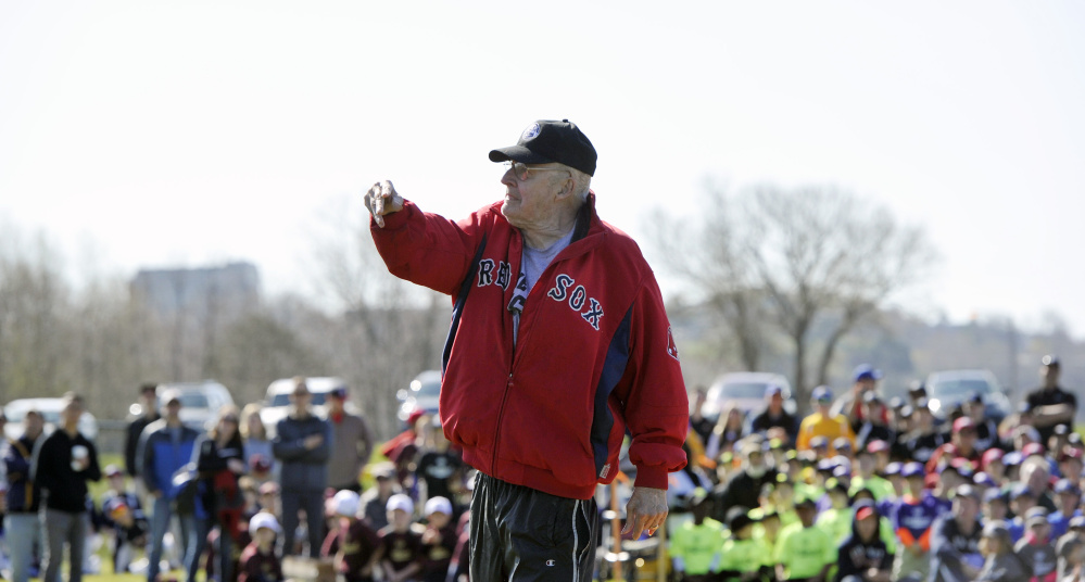 Longtime Little League coach Ron Farr, 78, throws out the opening pitch during Little League Opening Day ceremonies on Saturday. Farr has been coaching little league in Portland for 54 years.