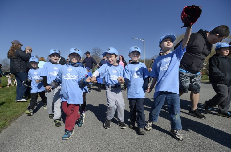 Little Leaguers from the Poland Spring team march in the parade during Opening Day Ceremonies at Payson Park in Portland on Saturday. Portland Little League has 62 teams competing with 680 participants. 