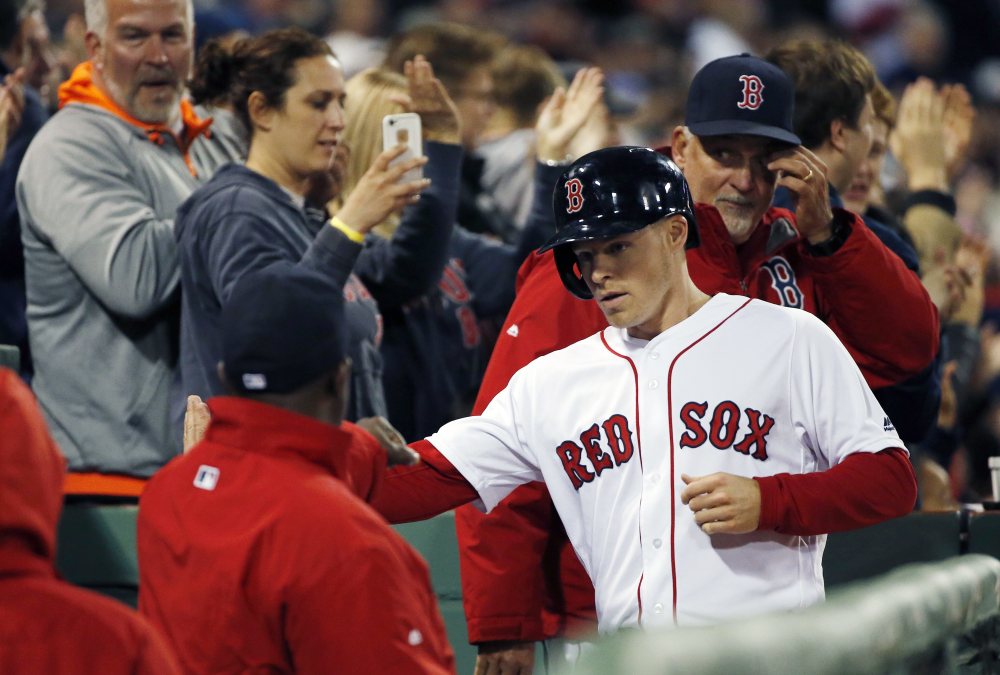 Brock Holt celebrates after scoring on a triple by Jackie Bradley Jr. during the sixth inning.