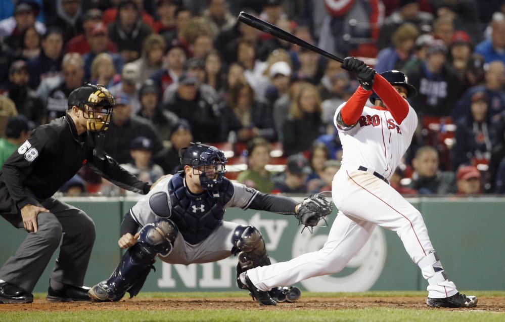 Boston outfielder Jackie Bradley Jr. follows through on a two-run triple in front of the Yankees' Brian McCann during the seventh inning in Boston Saturday. (AP Photos/Michael Dwyer)