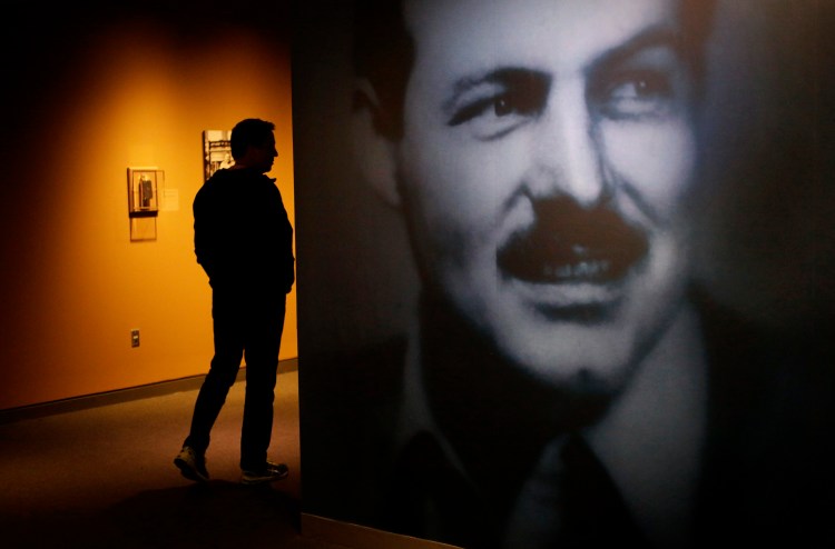 A museum visitor walks past a photograph of Ernest Hemingway in an exhibit at the John F. Kennedy Presidential Library and Museum in Boston.    The Associated Press