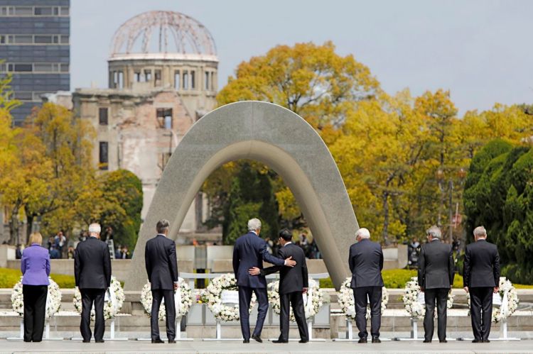 U.S. Secretary of State John Kerry puts his arm around Japan's Foreign Minister Fumio Kishida after they and fellow G7 foreign ministers laid wreaths at the cenotaph at Hiroshima Peace Memorial Park and Museum in Hiroshima, Japan. Reuters