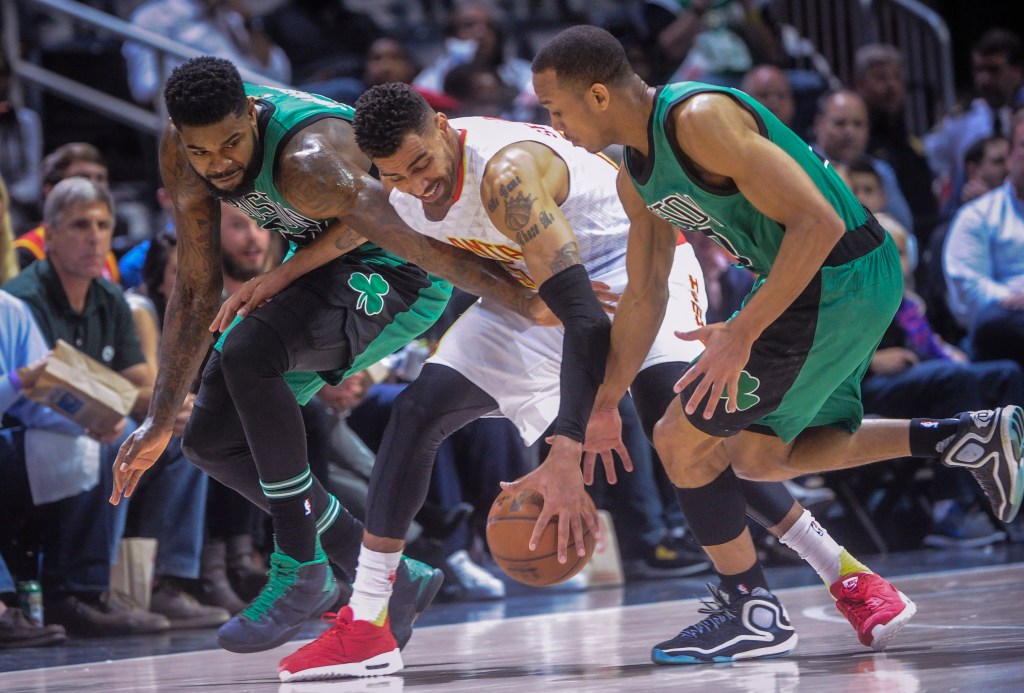 Atlanta forward Thabo Sefolosha, center, gets a hand on the ball before the ball was knocked away, as Boston forward Amir Johnson, left, and guard Avery Bradley defend during the first half Saturday in Atlanta. The Associated Press