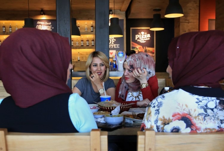 Iraqis have lunch at a restaurant in Baghdad as the food business is booming, despite the war and an economic slump, as entrepreneurs find restaurants and eateries a safe business bet.    The Associated Press