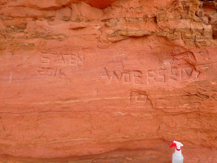This National Park Service photograph shows carved graffiti at Frame Arch at Arches National Park. 