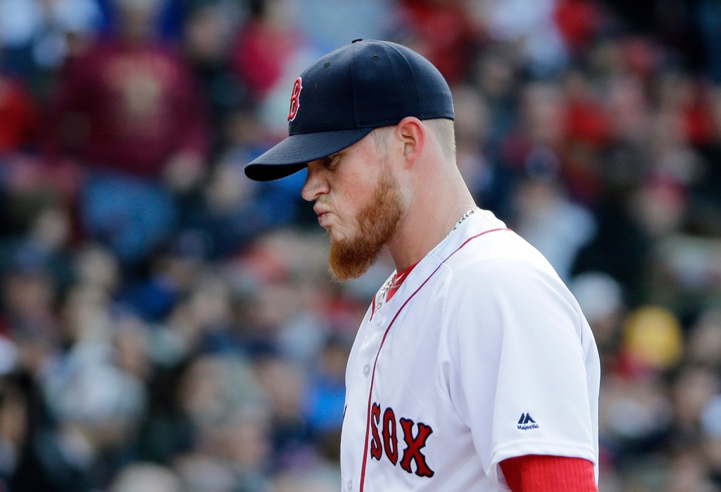 Red Sox closer Craig Kimbrel walks to the dugout after giving up three runs in the ninth inning. Kimbrel, making his Fenway Park debut for the Red Sox, took the loss. "I went out and beat myself," he said afterward.
