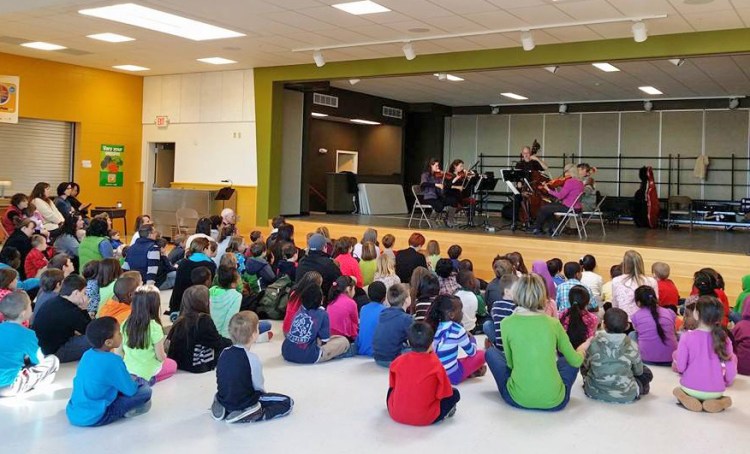 Students at Portland's Reiche Schoo watch a performance by musicians from the Portland Symphony Orchestra in this Culture Club event. PSO photo