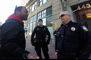 Pastor Andrew March speaks with police Lt. William Preis in front of Planned Parenthood in Portland. 