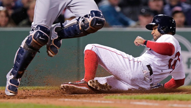 Tampa Bay catcher Curt Casali makes a bases-loaded force out at home as Boston's Chris Young slides toward the plate in the third inning Tuesday night.   The Associated Press