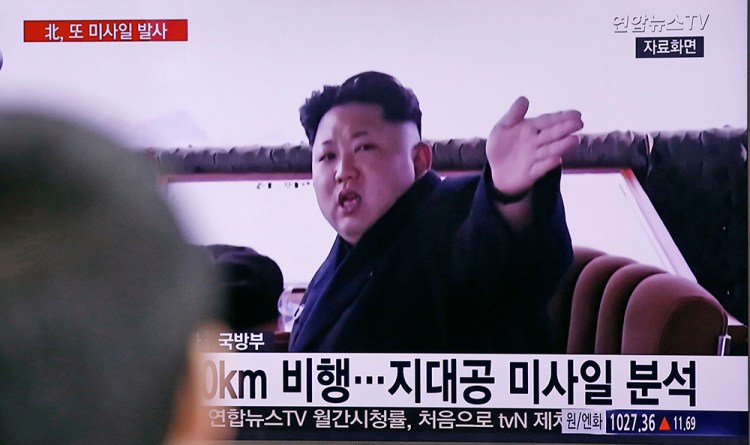 A South Korean man watches a news program in a Seoul Railway Stations howing footage of North Korean leader Kim Jong Un recently. The Korean letters at bottom read: "Analysis, the surface-to-air missile." The Associated Press