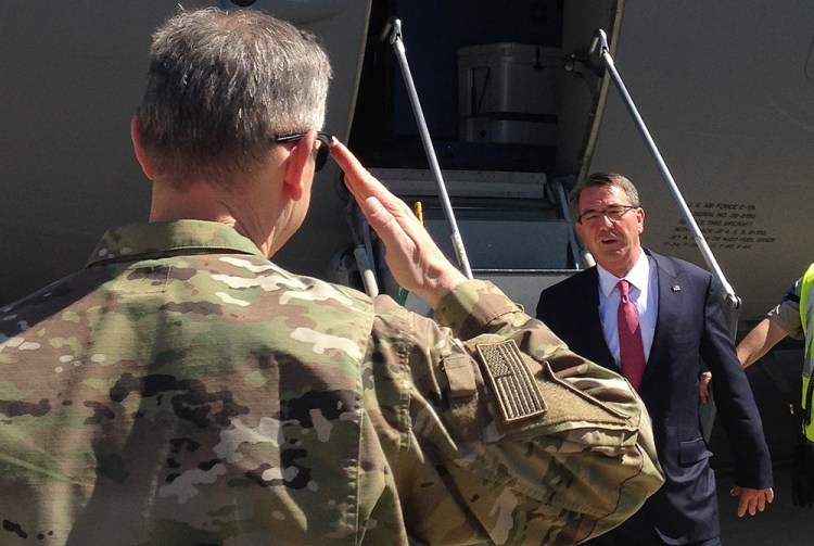 Defense Secretary Ash Carter is greeted by Lt. Gen. Sean MacFarland, top U.S. commander for the fight against the Islamic State, as he arrives Monday in Baghdad. The Associated Press