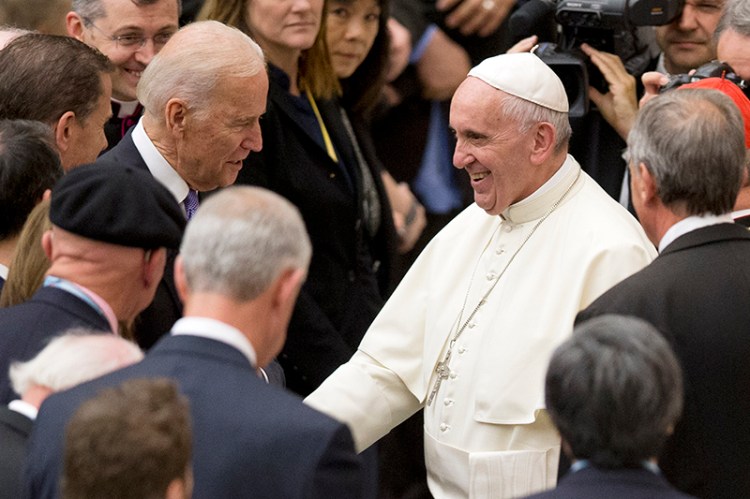 Pope Francis shakes hands with Vice President Joe Biden as he takes part at a congress on the progress of regenerative medicine at the Vaticano