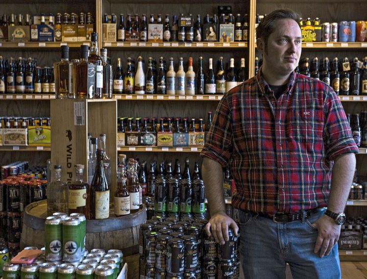Kevin Casey of Old Port Spirits & Cigars on Commercial Street in Portland has partnered with Boston-based Drizly, which connects the retailer to customers online.