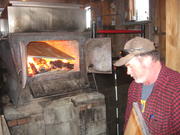 Russell Parsons keeps the wood fire burning last week to boil sap.