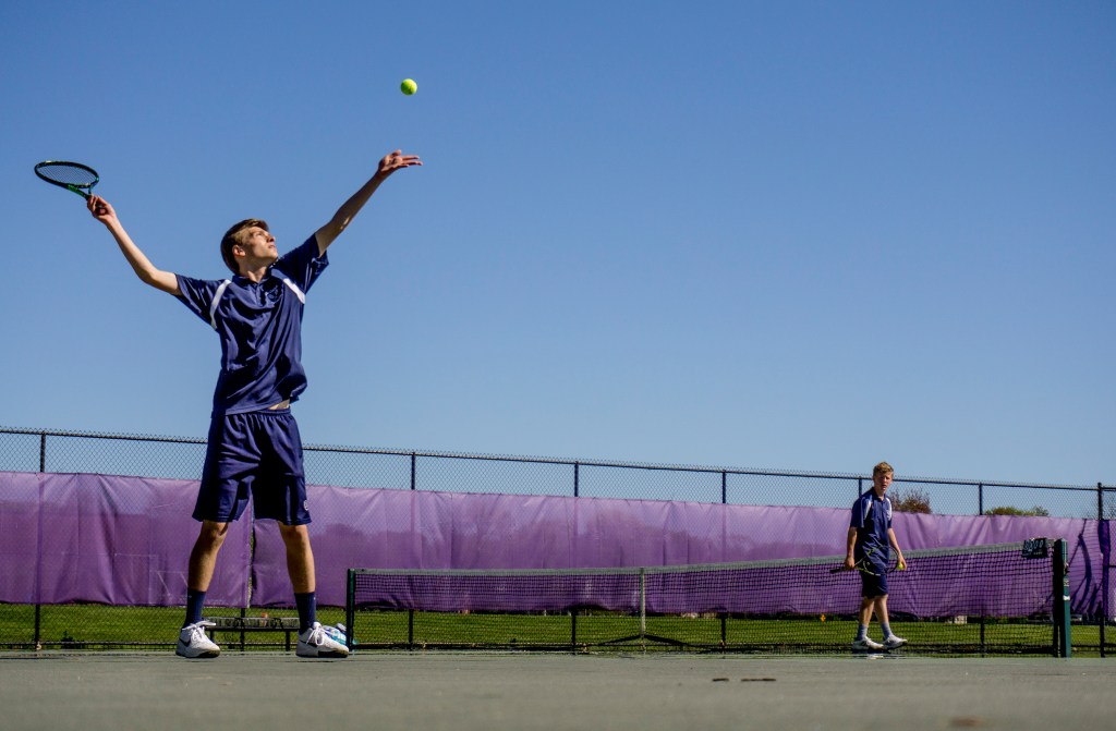 Peter Barry, a junior at Portland, tosses up a ball to serve to Isaac Finberg of Deering during a tennis match at Deering Wednesday.
Gabe Souza/Staff Photographer