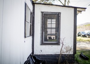 A cat sits in the window of a small trailer in Dixfield. Gabe Souza/Staff Photographer