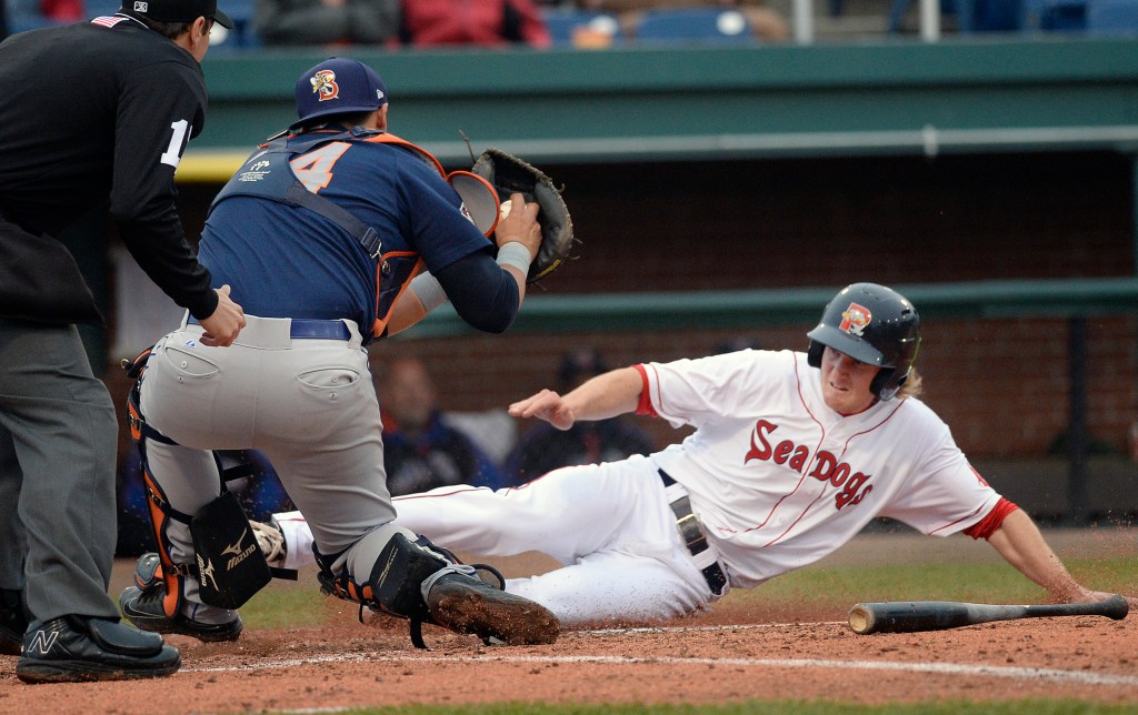 Portland's Derek Miller tries to slide under the tag of Binghamton catcher Xorge Carrillo in the first game of Friday's doubleheader at Hadlock Field. Miller was out on the play. 
Shawn Patrick  Ouellette/Staff Photographer