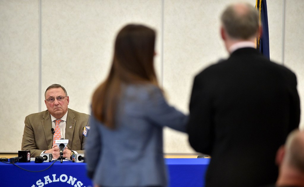 Gov. Paul LePage listens as a resident of Oakland asks a question during Tuesday's town hall meeting at Messalonskee Middle School in Oakland. Michael G. Seamans/Morning Sentinel