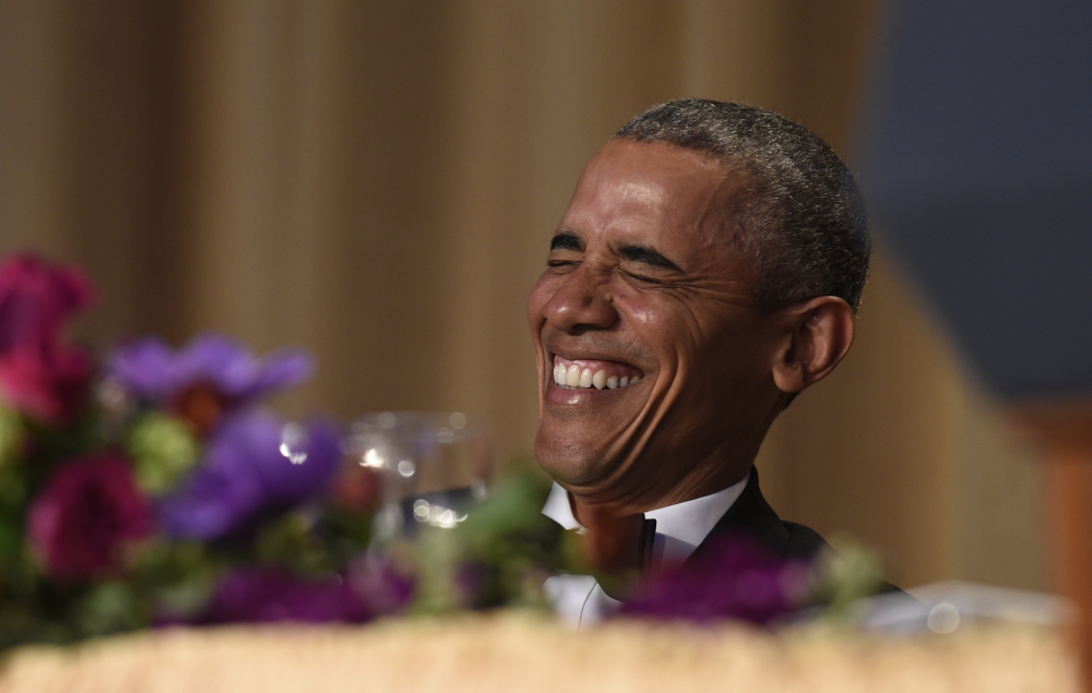 President Obama laughs as he listens to Larry Wilmore, the guest host from Comedy Central, speak at the annual White House Correspondents' Association dinner Saturday. (AP Photo/Susan Walsh)