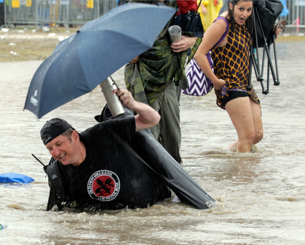 The Acura Stage area is flooded after a storm dumped several inches of rain on the second Saturday of the New Orleans Jazz Fest at the Fair Grounds.