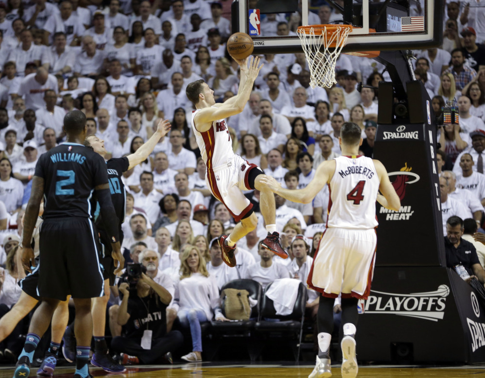Miami guard Goran Dragic shoots against the Charlotte Hornets in the first half Sunday in Miami.
