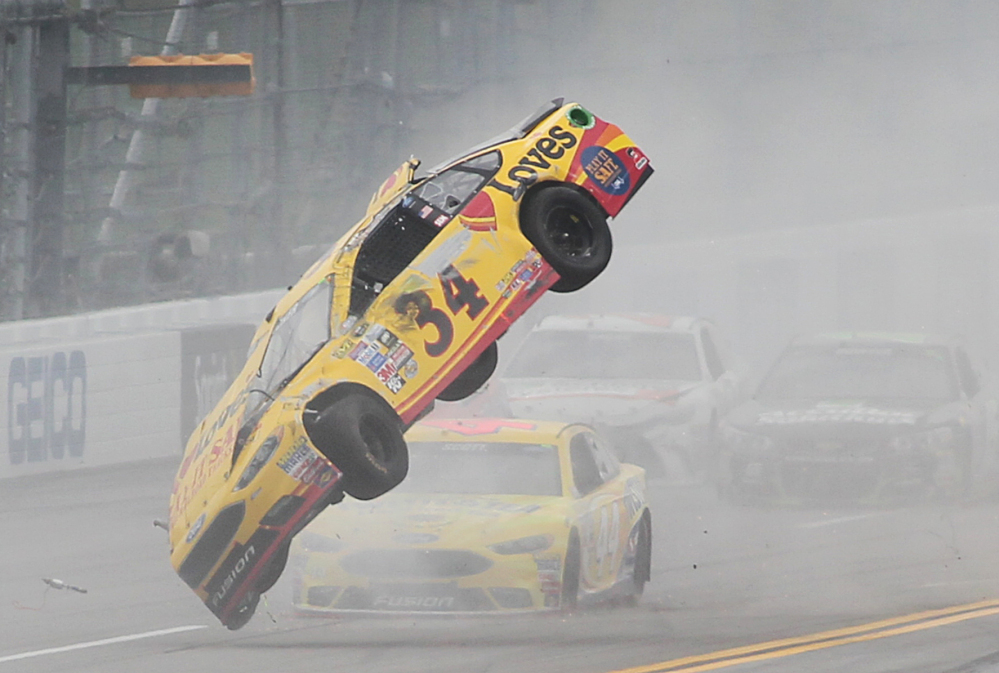Chris Buescher's car goes airborne during a crash in the Sprint Cup race Sunday at Talladega Superspeedway. The car flipped three times, but Buescher walked away uninjured.