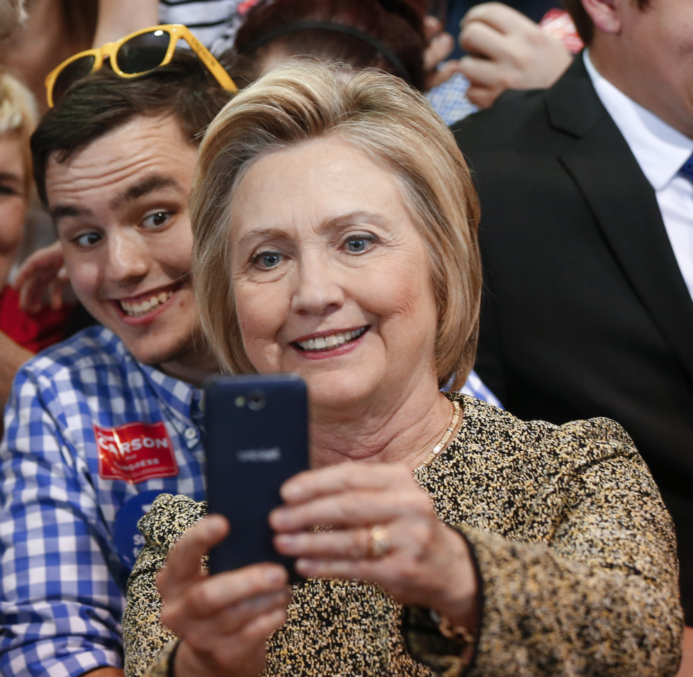 Democratic presidential candidate Hillary Clinton takes photographs with audience members during a campaign stop in Indianapolis, Sunday, May 1, 2016.  (AP Photo/Paul Sancya)
