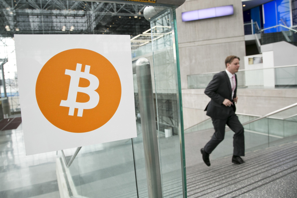 In this April 7, 2014 file photo, a man arrives for the Inside Bitcoins conference and trade show in New York.