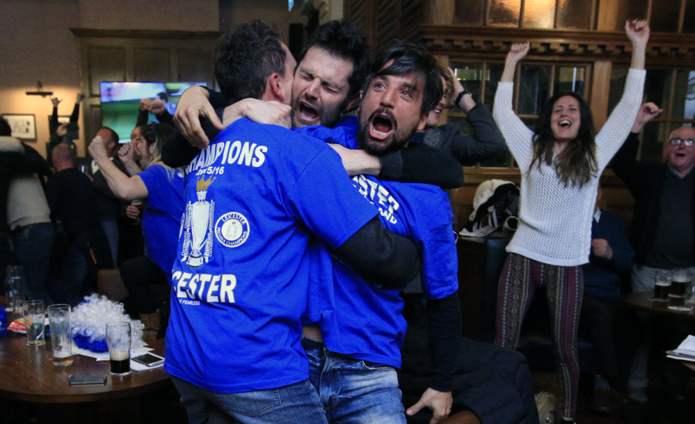 Leicester City fans roar their approval in Hogarths public house in Leicester, England, after a 2-2 Chelsea-Tottenham tie Monday gave Leicester City the Premier League title.
