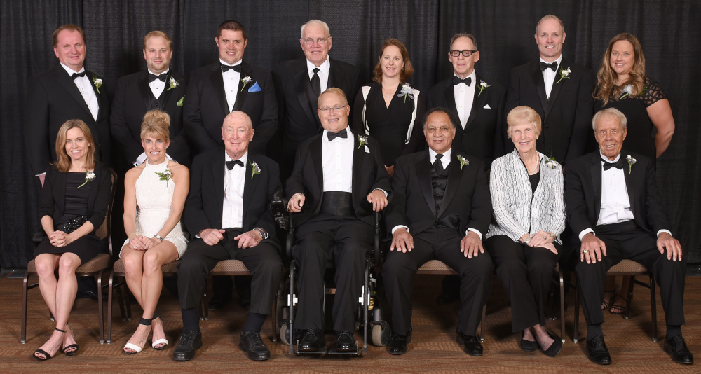 The Maine Sports Hall of Fame held its annual induction ceremony Sunday at Bangor's Cross Insurance Center. The 2016 class includes: Front row, from left to right – Kristin Barry, Sheri Piers, Jack Kelley, Travis Roy, Ralph Payne, Pennie Page Cummings and Ed Phillips; Back row – Royce Cross, Woodrow Cross II and Jonathan Cross of the Cross family, HOF chairman Richard Whitmore, Kirsten Clark-Rickenbach, Dan Hamblett, Doug Friedman and Amy Vachon.