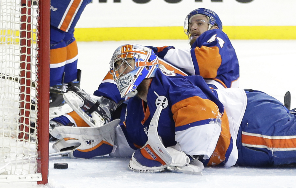 Islanders goalie Thomas Greiss and defenseman Calvin de Haan look up at the referee after the puck was knocked in from above the net. The referee called a no goal on the play.