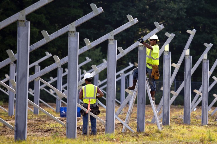 Workers for RBI Solar Inc. install supports for solar panels on land owned by Bowdoin College at the former Brunswick Naval Air Base. The 1.2-megawatt array is now the largest in Maine, but Yarmouth-based Ranger Solar plans a 50-megawatt array in Sanford.