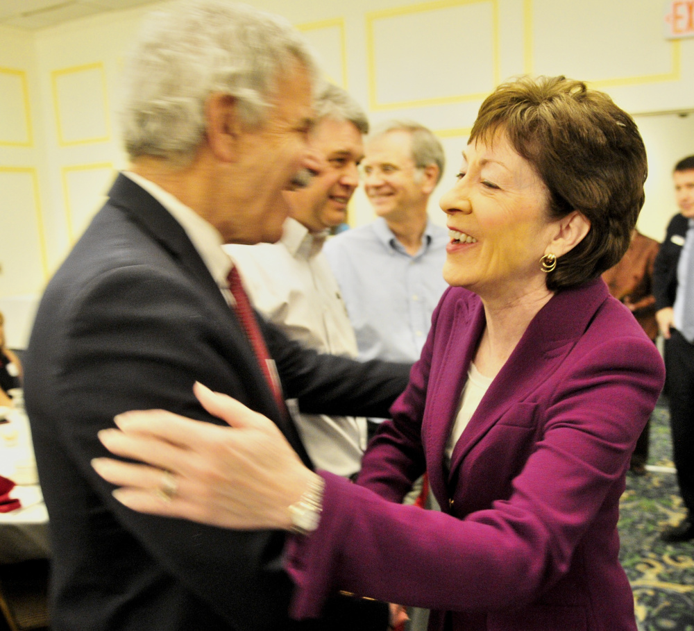 Maine Sen. Roger Katz, R-Augusta, greets U.S. Sen. Susan Collins, R-Maine, on Wednesday at the Kennebec Valley Chamber of Commerce luncheon celebrating women leaders in the region.