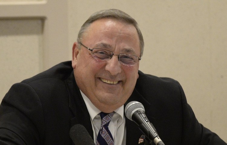 Gov. Paul LePage laughs during Wednesday's town hall forum in Lewiston. Speaking of a possible Trump administration, he told the audience at one point, "So what about if I become the ambassador to Canada in the summer and Jamaica in the winter?"