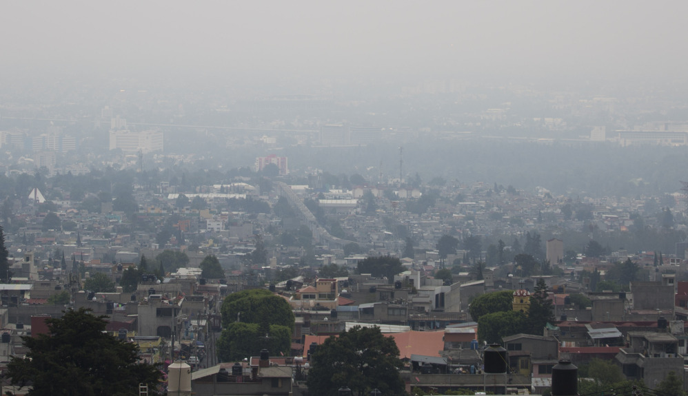 Air pollution hangs over Mexico City on Tuesday despite a cut in traffic. A new pollution alert will require 40 percent of cars and trucks to keep off the streets Thursday.