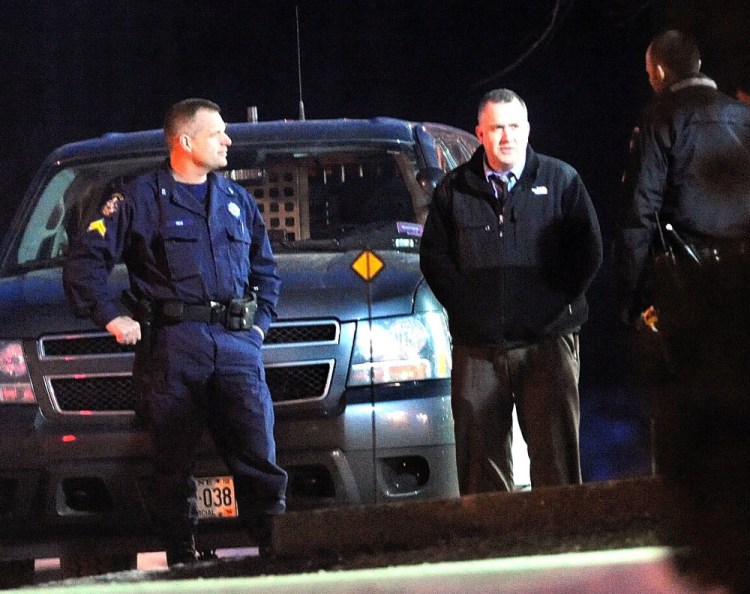 Deputy Chief Chip Rumsey, right facing, stands with officers in 2013 outside KeyBank on Kennedy Memorial Drive in Waterville after a man robbed the branch.