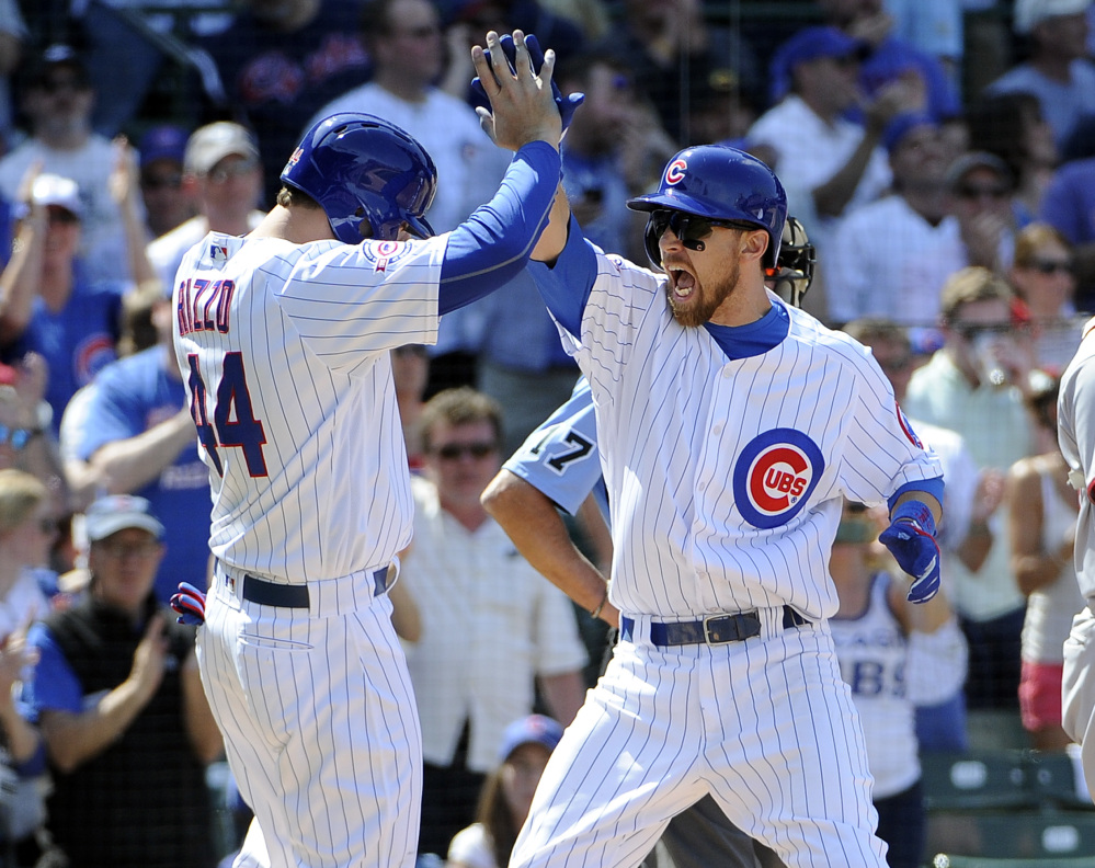 The Cubs' Ben Zobrist, right, is greeted by Anthony Rizzo after Zobrist's three-run homer against the Nationals during an 8-6 Chicago win Friday.