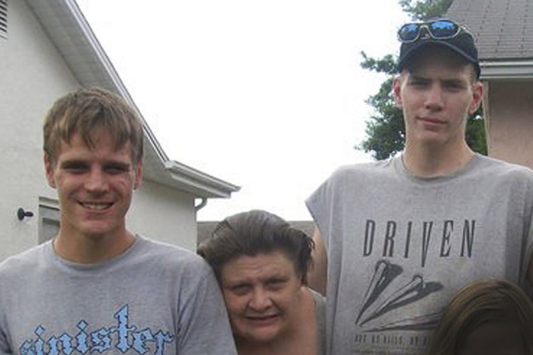 This 2010 family photo shows the twin brothers, Jarred, left ,and Timothy Johnson, with their mother, JoAnn Winters, who died in January. Jarred says the family petitioned the court to involuntarily commit Timothy, but the order was never carried out. Timothy F. Johnson now stands accused in the slaying of 52-year-old Judith Therianos in New Port Richey, Fla., in March. (Note: This photo has been intentionally blurred to protect the identity of a minor, lower right.)