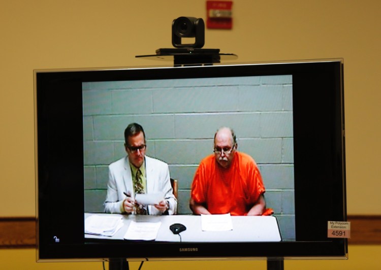 Old Orchard Beach Fire Chief Ricky Plummer, accused of arson, appears on screen Monday during a video appearance at Springvale District Court. With him is attorney B.J. Broder.