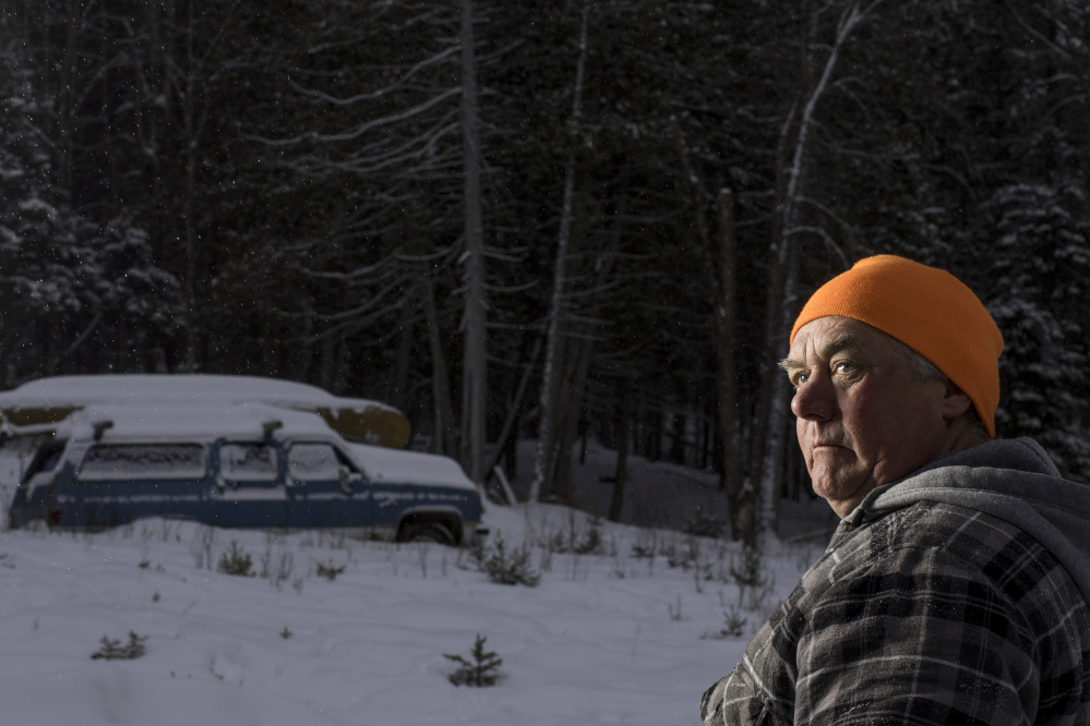 Carter McBreairty, 56, stands outside his Allagash home near dusk. Unaware that a visitor to the area was an undercover agent, McBreairty allowed the man who was investigating him to stay in his house for days, even when McBreairty was at his construction job in midcoast Maine.