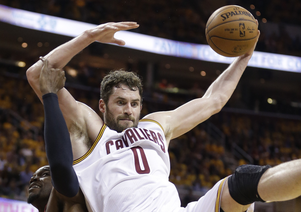 Cavaliers forward Kevin Love grabs during Game 2 of Cleveland's series against Atlanta. Along with 18.9 points per game, Love is averaging 12.5 rebounds in the playoffs, helping the Cavaliers open with an 8-0 run.