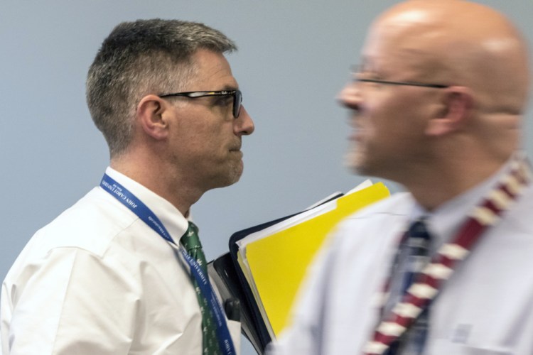 SAD 6 Superintendent Frank Sherburne, left, walks past school board member Daniel Kasprzyk before entering an executive session Tuesday. Kasprzyk tried to stop the board from using its own counsel to investigate a possible nepotism policy violation, but was voted down.