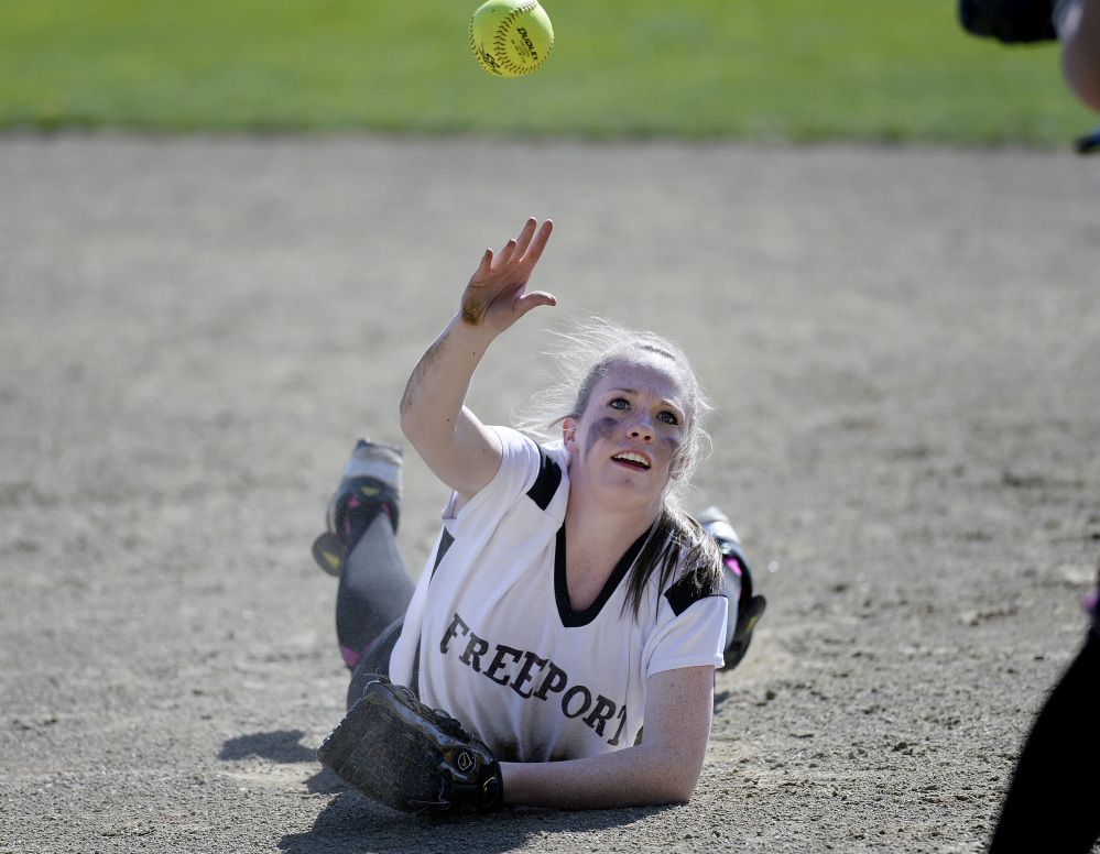 Freeport's Elizabeth Wiest tosses the ball to first base from the ground after making a diving stop on Wednesday against Gray-New Gloucester. The Patriots went on to a 10-0 win.